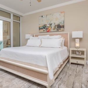 Retreat to the king master suite with cozy bedding and drift off to the sound of the waves from the balcony