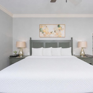 Unwind after a day at the beach in this elegant king master suite surrounded by stylish accents