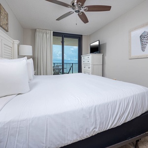 Enjoy restful nights in the master bedroom featuring a king bed, elegant decor, and beachfront balcony access