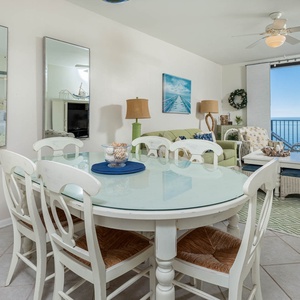 Gather around the oval dining table, enjoying the inviting decor and beach light streaming through the windows