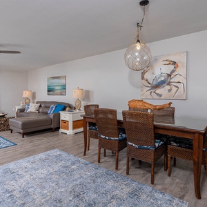 Relax in the inviting living area with comfortable seating, a dining table, and beautiful coastal decor