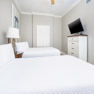 Retreat to this queen guest bedroom, where plush bedding welcomes restful nights and a TV adds entertainment for your stay