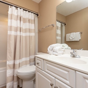 Freshen up in this guest bath in the relaxing shower or soothing tub before an exciting beach day