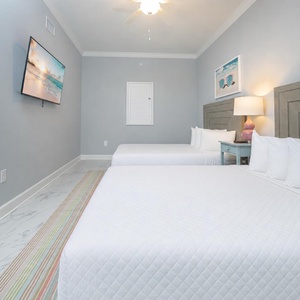 Rest in this queen guest suite featuring vibrant decor, and a wall-mounted TV for your favorite show