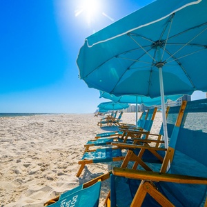 Relax on the sandy beach while watching families play and the gentle waves roll in from your beachfront rental