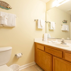 Refresh in the guest bathroom featuring a spacious vanity, cheerful decor, and a convenient shower