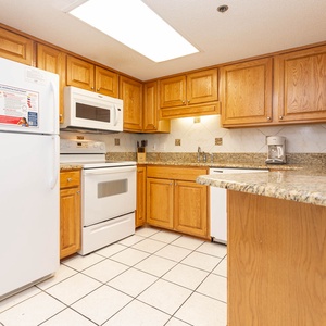 Prepare meals with ease in this inviting kitchen featuring ample counter space and white appliances
