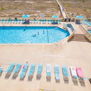 Soak up the sun by the pool on comfortable loungers, embracing the vibrant beach vibe with your family