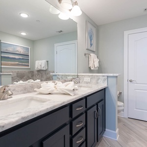 Refresh in the master bath after a day at the beach with a soothing jetted tub and relaxing walk-in shower