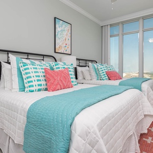 Wake to breathtaking sights in this queen guest suite with two cozy beds and expansive views from the windows