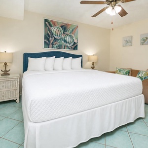 Rest on the plush king bed or curl up on the cozy sofa, savoring the inviting beach decor in this suite