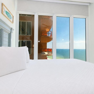 Relax in this guest suite with two queen beds, beach decor, and coastline views of the horizon