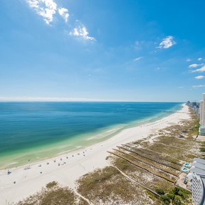 Gaze at panoramic beach views from your spacious balcony, savoring peaceful moments as waves gently lap the shore