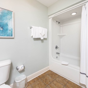 Indulge in a refreshing rinse in this guest bath, where calming colors and plush towels enhance your rejuvenation