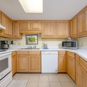 Kitchen features oak cabinetry, a coffee maker, and a convenient breakfast bar area for all your entertaining needs