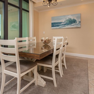 Gather around the elegant dining table, savoring meals while enjoying the coastal views through the expansive windows