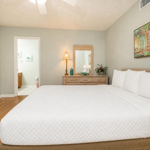 Relax in this guest room with a queen bed after a fun day at the beach