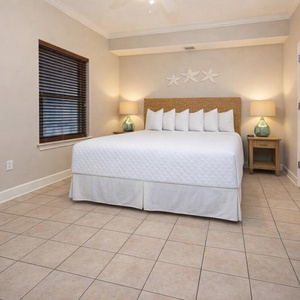Guest bedroom featuring a plush king bed, stylish decor, and warm lighting for a cozy atmosphere