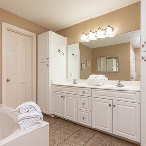 Refresh in the master bath after a day at the beach with a soothing jetted tub and relaxing walk-in shower