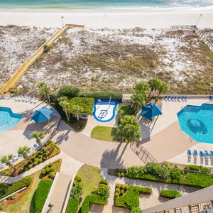 Enjoy the inviting pool area surrounded by lush landscaping, perfect for relaxation and fun in the sun