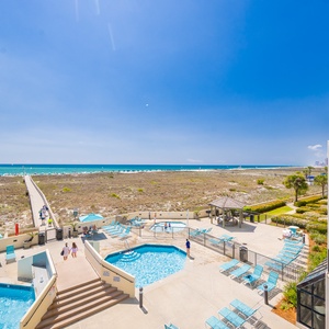 Breathe in fresh coastal air on your balcony, savoring the stunning views and vibrant beach vibe with family