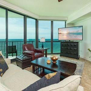 Relax in this inviting living area with large windows offering breathtaking views and comfortable seating options