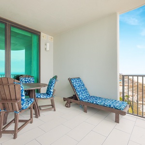 Relax on the balcony with a dining set and lounge chair, perfect for enjoying fresh air and coastal views