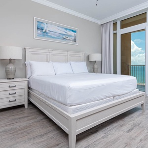 Retreat to the king master suite with cozy bedding and drift off to the sound of the waves from the balcony