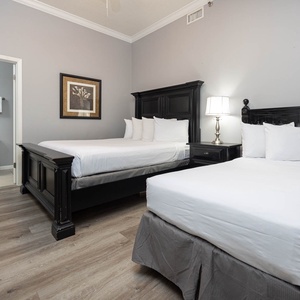 Rest in this inviting guest room with a queen and twin bed, stylish decor, and a cozy atmosphere for a restful stay