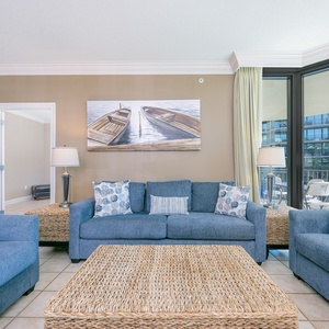 Feel the warmth as you gather in the inviting living area, surrounded by soft furnishings and coastal decor
