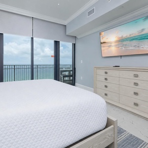 Unwind in this inviting master bedroom with a king bed and sleep peacefully to the sound of gentle waves