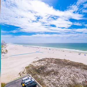 Gaze at the stunning shoreline from your balcony, where vibrant beach life unfolds just beyond your retreat
