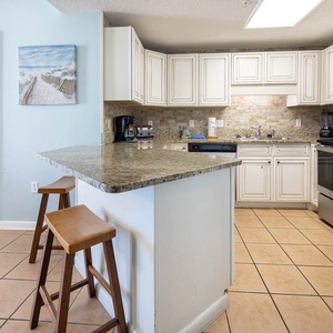 Cook meals in the bright kitchen featuring granite countertops, stainless appliances, and a welcoming atmosphere