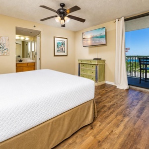 Relax in the master suite with a king bed and enjoy tranquil views from your balcony under the ceiling fan light