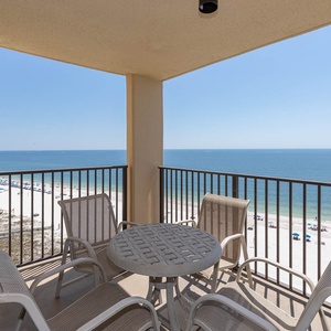Enjoy the serene beachfront view from the balcony, featuring a round table and four comfortable chairs for relaxation