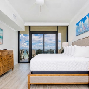 Serene master suite featuring a king bed, stylish decor, and beachfront balcony access