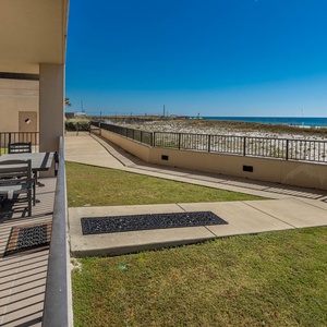 Relax on the spacious patio with comfortable seating and enjoy the fresh air and views of the tranquil beach
