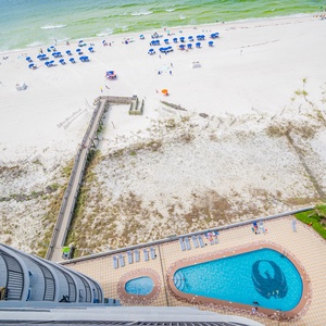 Take in the view of the inviting pool area and beach, perfect for relaxation and fun in the sun