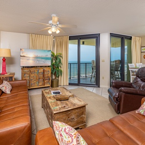 Vibrant living area features a green sofa with queen sleeper, cozy armchairs, rustic coffee table, and playful beach artwork