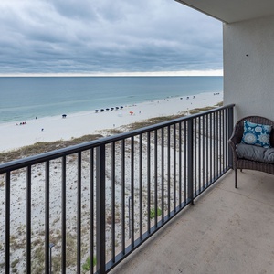 Enjoy breathtaking views from this cozy balcony, featuring comfortable seating and a serene beachside atmosphere