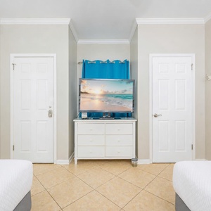 Enjoy cozy movie nights on the double beds while making lasting memories with family in this guest bedroom