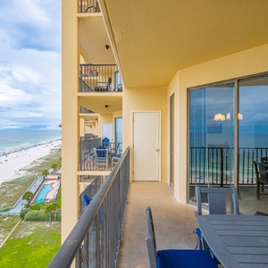 Enjoy a panoramic view of the beach, featuring white sand and colorful umbrellas under a clear blue sky