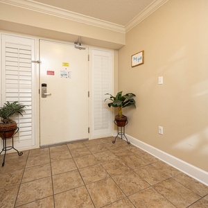 Step into a welcoming entryway, where a lush plant adds a touch of nature, setting a peaceful vibe for your stay
