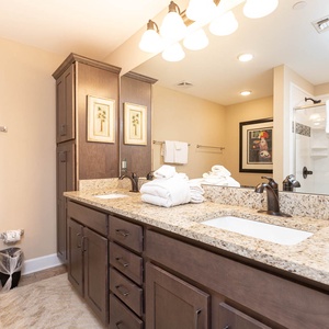 Refresh after a beach day at the elegant master bath in the soothing tub or refreshing walk-in shower with tile accents