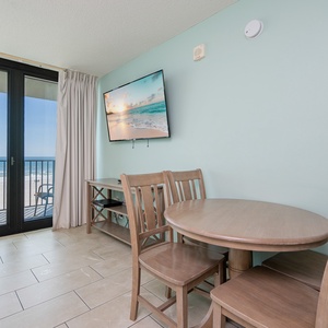 The dining area invites you to enjoy meals while watching waves shimmer beyond your balcony door