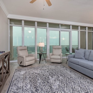 Unwind in the living room, featuring a queen sofa sleeper, while soaking in the coastal breeze from the balcony