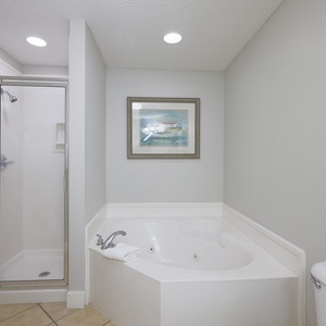 Indulge in relaxation in the master bath with a refreshing walk-in shower and soothing jetted tub
