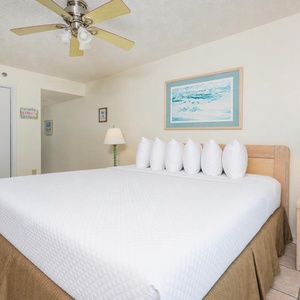 Master bedroom featuring a king bed, a ceiling fan, and beach decor for a calming atmosphere
