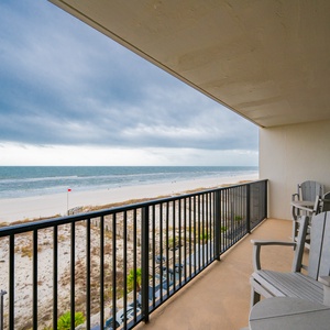 This balcony offers a stunning beachfront view with comfortable seating for relaxation