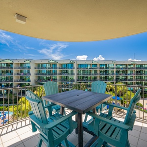 Savor the soothing breeze from the balcony while enjoying the stunning bay views and pool area below